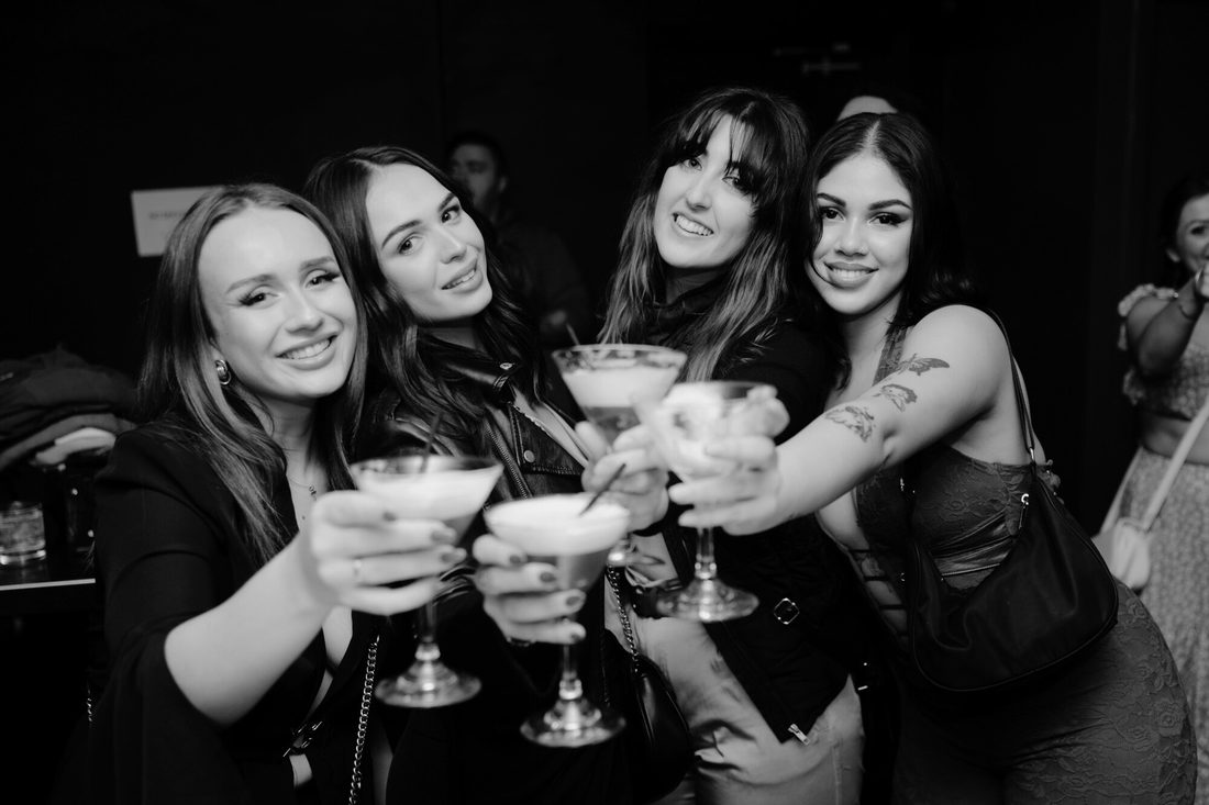 Group enjoying cocktails at Ferrara Karaoke Bar