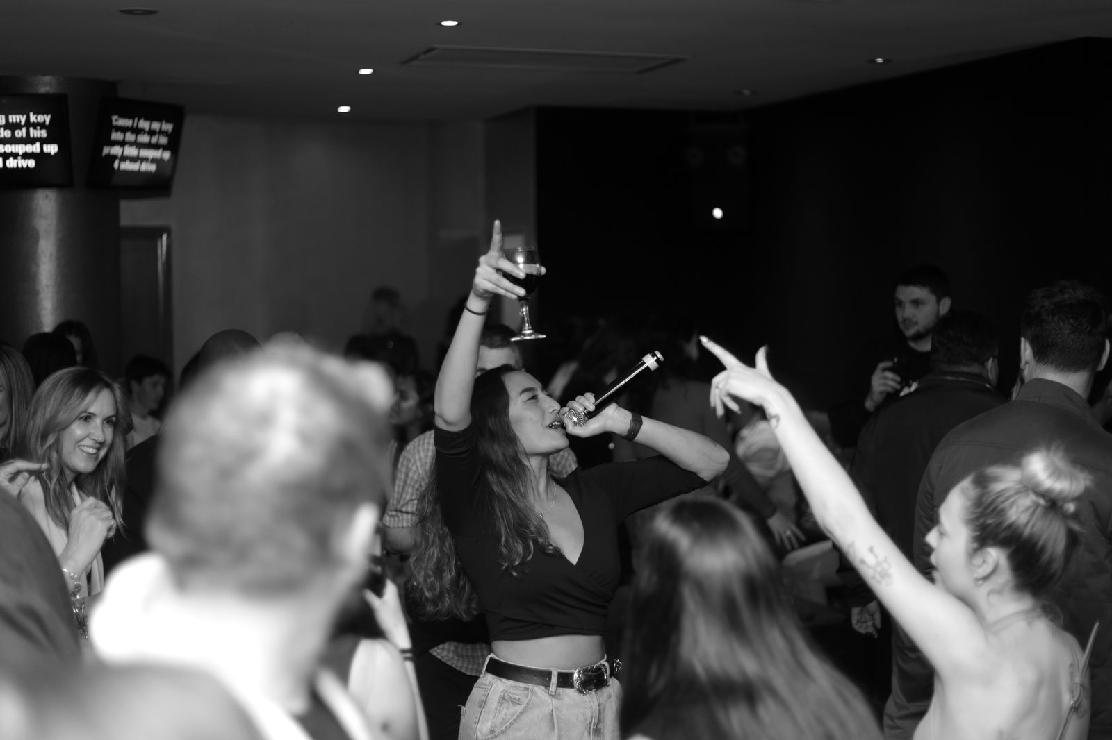 Singer performing to a crowd at Ferrara Karaoke Bar